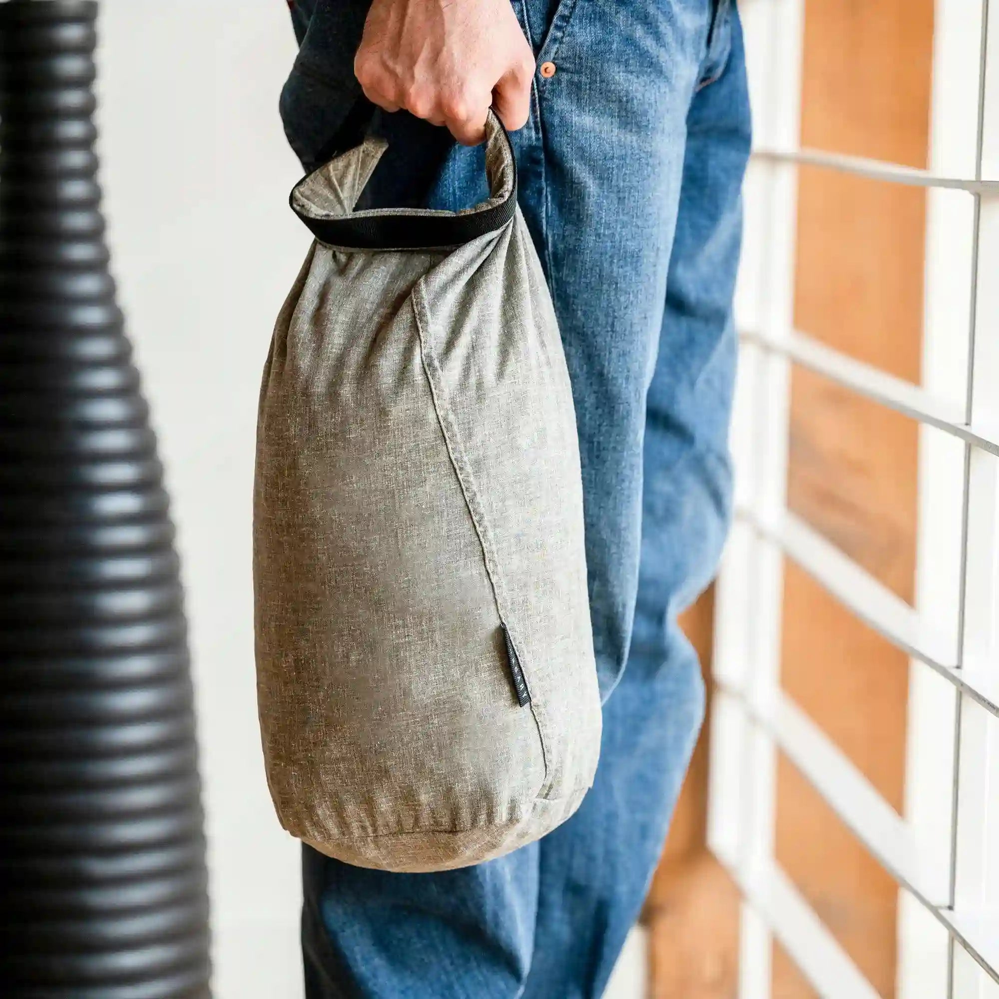 A man holding his antibacterial hemp laundry bag.