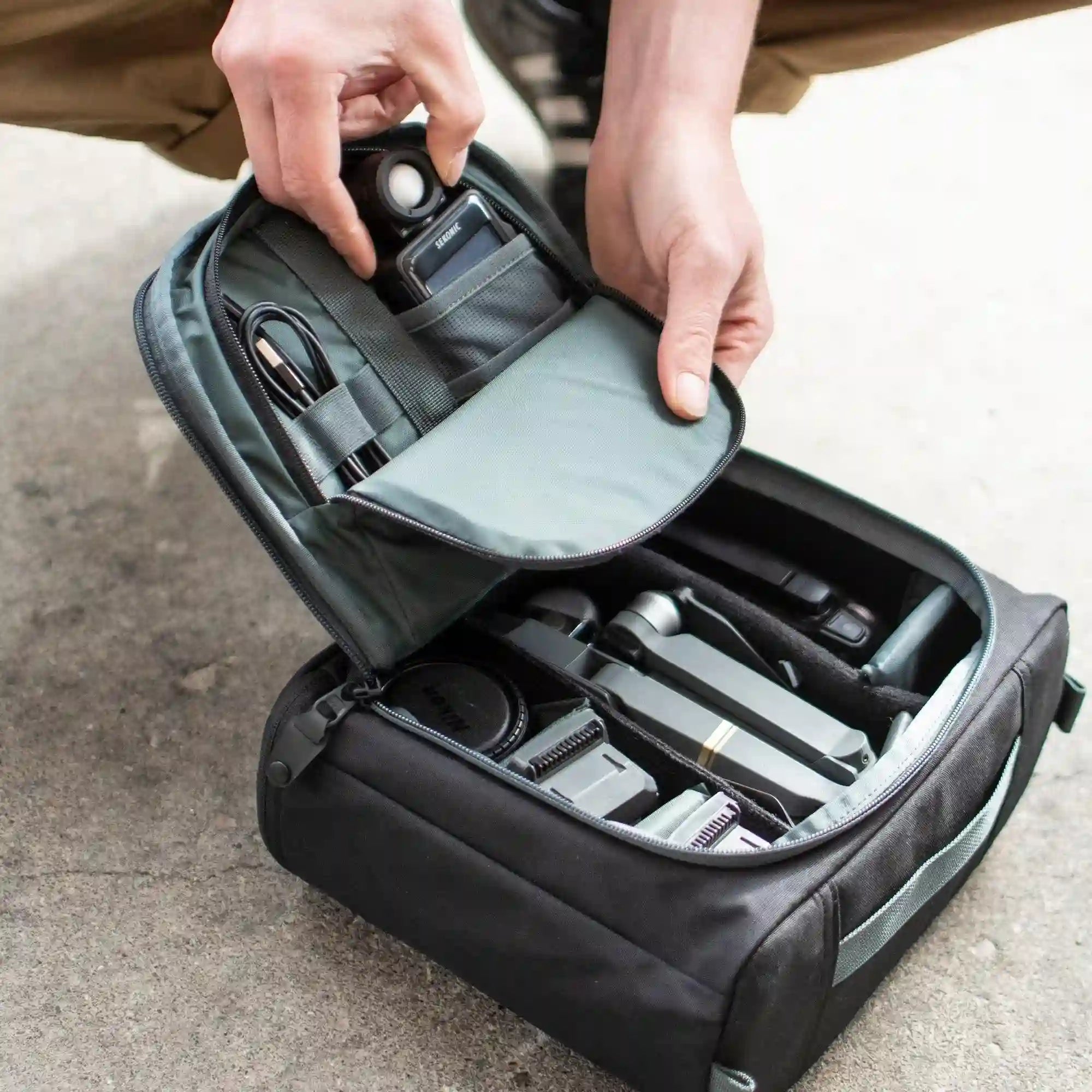 A man organizes his camera gear in the MK-2 Camera Cube.